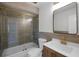 Updated bathroom with a bathtub, glass shower, and modern fixtures at 2725 Lakewood Ln, Eustis, FL 32726