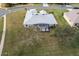 Single-story house with a screened lanai, backyard view at 27302 Orchid Glade St, Leesburg, FL 34748