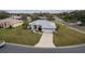 Single-story house with a red door and attached garage, seen from above at 27302 Orchid Glade St, Leesburg, FL 34748