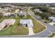 Single-story house with a red door and attached garage, neighborhood view at 27302 Orchid Glade St, Leesburg, FL 34748