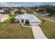 Single-story house with a red door and attached garage, aerial view at 27302 Orchid Glade St, Leesburg, FL 34748