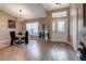 Dining area with hardwood floors, view of kitchen and entry at 27302 Orchid Glade St, Leesburg, FL 34748