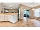 Kitchen with white cabinets, tile floors, and view of Gathering room at 27302 Orchid Glade St, Leesburg, FL 34748