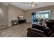 Living room with hardwood floors, sliding glass doors to lanai at 27302 Orchid Glade St, Leesburg, FL 34748