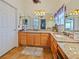 Double vanity bathroom with granite countertops and updated lighting at 2762 Morven Park Way, The Villages, FL 32162