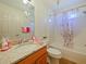 Bathroom with granite vanity and shower/tub combo at 2762 Morven Park Way, The Villages, FL 32162