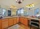 Double vanity bathroom with granite countertops and elegant chandelier at 2762 Morven Park Way, The Villages, FL 32162