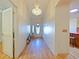 Bright entryway with hardwood floors and chandelier at 2762 Morven Park Way, The Villages, FL 32162