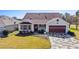 Single-story home with a red door and patterned driveway at 2762 Morven Park Way, The Villages, FL 32162