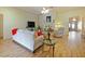 Open living room featuring a cozy fireplace and hardwood floors at 2762 Morven Park Way, The Villages, FL 32162