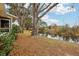 Backyard with pond view and large oak tree at 312 Brigadoon Cir # 312, Leesburg, FL 34788