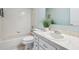 Bathroom with tub, sink, and white cabinets at 312 Brigadoon Cir # 312, Leesburg, FL 34788