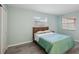 Bedroom with teal quilt, wood flooring and window at 312 Brigadoon Cir # 312, Leesburg, FL 34788