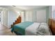 Light teal bedroom with wood flooring, large closet, and ensuite bathroom at 312 Brigadoon Cir # 312, Leesburg, FL 34788