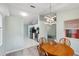 Bright dining area with wood table and chairs, kitchen view at 312 Brigadoon Cir # 312, Leesburg, FL 34788