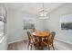 Light-filled dining area with wood table and four chairs at 312 Brigadoon Cir # 312, Leesburg, FL 34788