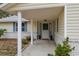 Inviting front porch entry with white columns and landscaping at 312 Brigadoon Cir # 312, Leesburg, FL 34788