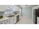 Kitchen features white cabinets and stainless steel appliances at 312 Brigadoon Cir # 312, Leesburg, FL 34788