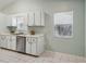 Kitchen boasts white cabinets and stainless steel appliances at 312 Brigadoon Cir # 312, Leesburg, FL 34788