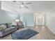 Light and airy living room with light gray sofa and a blue rug at 312 Brigadoon Cir # 312, Leesburg, FL 34788