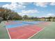 Outdoor pickleball courts with pond in background at 312 Brigadoon Cir # 312, Leesburg, FL 34788