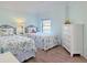 Twins bedroom with floral bedding and white dresser at 3253 Archer Ave, The Villages, FL 32162