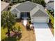 Single-story home with gray roof, attached garage, and landscaped yard at 3488 Sterling St, The Villages, FL 32162