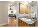 Bathroom with single sink vanity and view into living room at 3488 Sterling St, The Villages, FL 32162