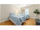 Two twin beds in a bright guest bedroom with light wood floors at 3488 Sterling St, The Villages, FL 32162