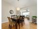 Bright dining room features hardwood floors and a wood dining table with seating for six at 3488 Sterling St, The Villages, FL 32162