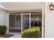 Enclosed porch with a white door, screen, and decorative metal gate at 3488 Sterling St, The Villages, FL 32162