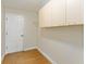 Laundry room with upper cabinets, closet, and wood floors at 3488 Sterling St, The Villages, FL 32162