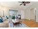 Living room with hardwood floors, a sofa, armchair, and a coffee table at 3488 Sterling St, The Villages, FL 32162