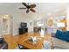 Open living room with hardwood floors, a cozy seating area, and a view into the dining area at 3488 Sterling St, The Villages, FL 32162