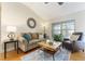 Living room with hardwood floors, a sofa, armchair, and a coffee table at 3488 Sterling St, The Villages, FL 32162