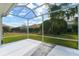 Screened patio overlooking the backyard and neighboring homes at 3488 Sterling St, The Villages, FL 32162