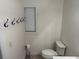 Simple bathroom with toilet and wall mounted hooks at 403 W Palm Ave, Bushnell, FL 33513