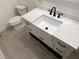 Modern bathroom featuring a farmhouse sink and quartz countertop at 403 W Palm Ave, Bushnell, FL 33513