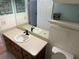 Bathroom with double vanity and toilet at 403 W Palm Ave, Bushnell, FL 33513