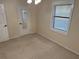 Bedroom with mirrored closet door and window at 403 W Palm Ave, Bushnell, FL 33513