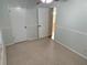 Bedroom with light green walls and door to hallway at 403 W Palm Ave, Bushnell, FL 33513