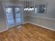 Bright dining room featuring hardwood floors and French doors at 403 W Palm Ave, Bushnell, FL 33513