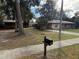 Ranch-style house with a large yard and trees at 403 W Palm Ave, Bushnell, FL 33513