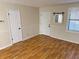 Living room with hardwood floors and a mirrored wall at 403 W Palm Ave, Bushnell, FL 33513