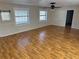 Bright living room featuring hardwood floors and large windows at 403 W Palm Ave, Bushnell, FL 33513