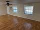 Living room showcasing hardwood floors and two windows at 403 W Palm Ave, Bushnell, FL 33513