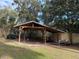 Wooden storage shed with a metal roof at 403 W Palm Ave, Bushnell, FL 33513