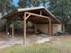 Wooden storage shed with a metal roof at 403 W Palm Ave, Bushnell, FL 33513