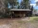 Wooden storage shed with a metal roof at 403 W Palm Ave, Bushnell, FL 33513