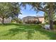 Serene backyard with lush lawn and a white bench at 4077 Greystone Dr, Clermont, FL 34711